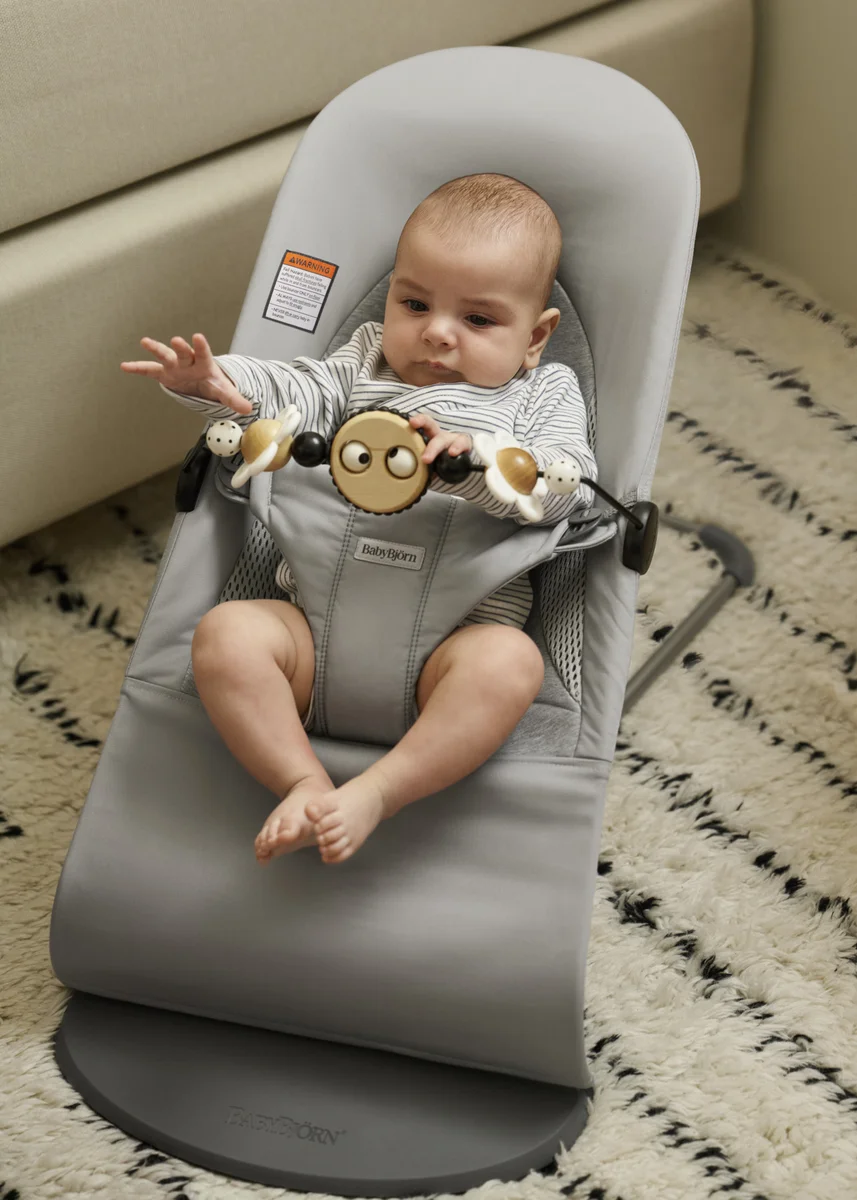 Baby bouncing in the BabyBjörn Bouncer Balance Soft with toy bar attached