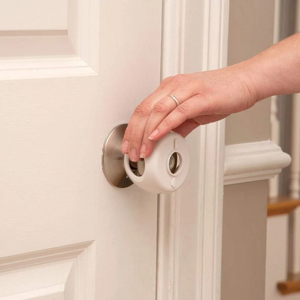 Safety 1st Grip 'n Twist door-knob cover installed on a white door