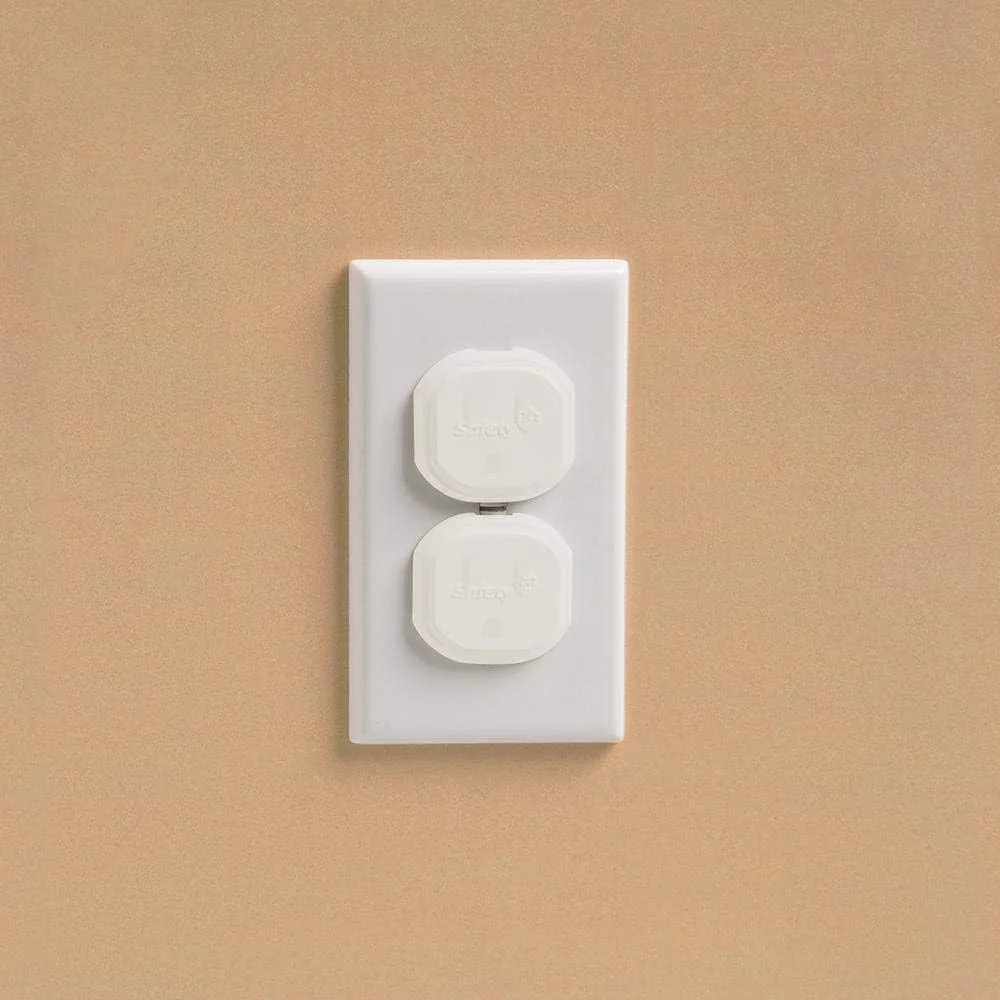 Safety 1st outlet plug cover installed over a wall electrical outlet