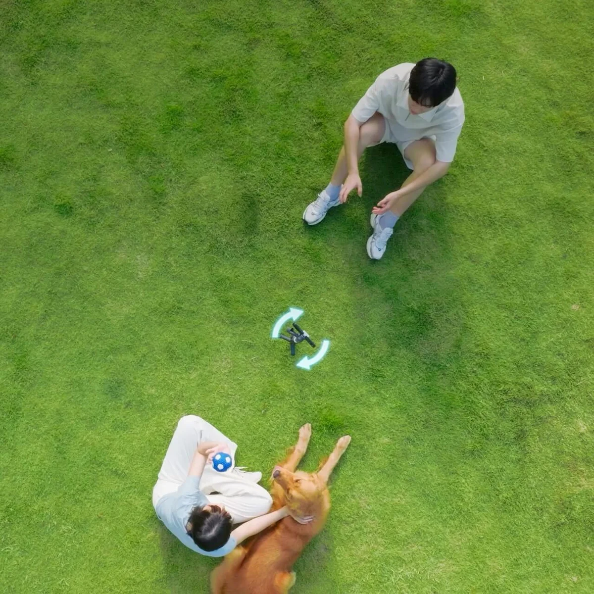 DJI Osmo Mobile 8 360-degree tracking shown from an aerial view with two people and a dog on grass