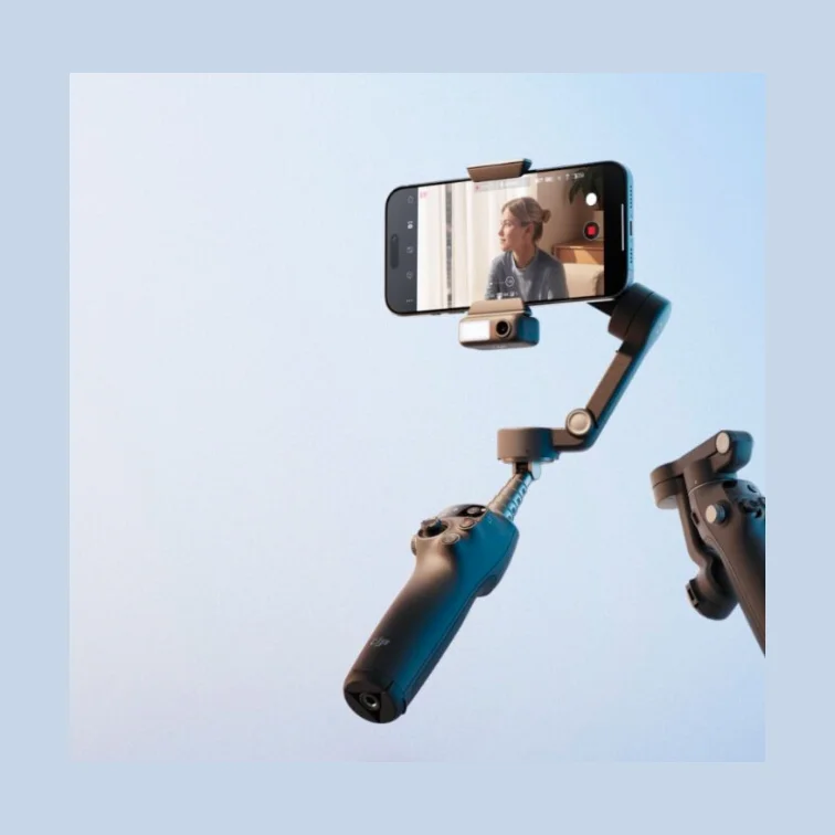 DJI Osmo Mobile 8 smartphone gimbal with phone mounted, extended shooting position on light blue background