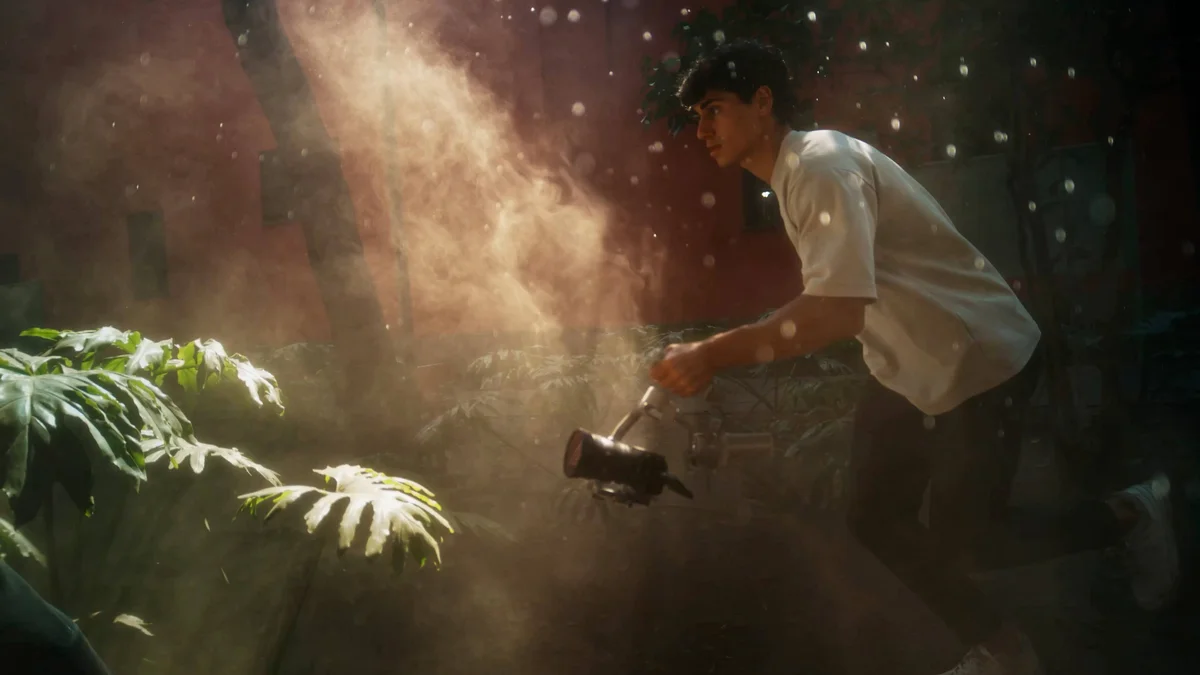 Filmmaker holding a DJI RS4 Mini gimbal while shooting in a dramatic outdoor environment