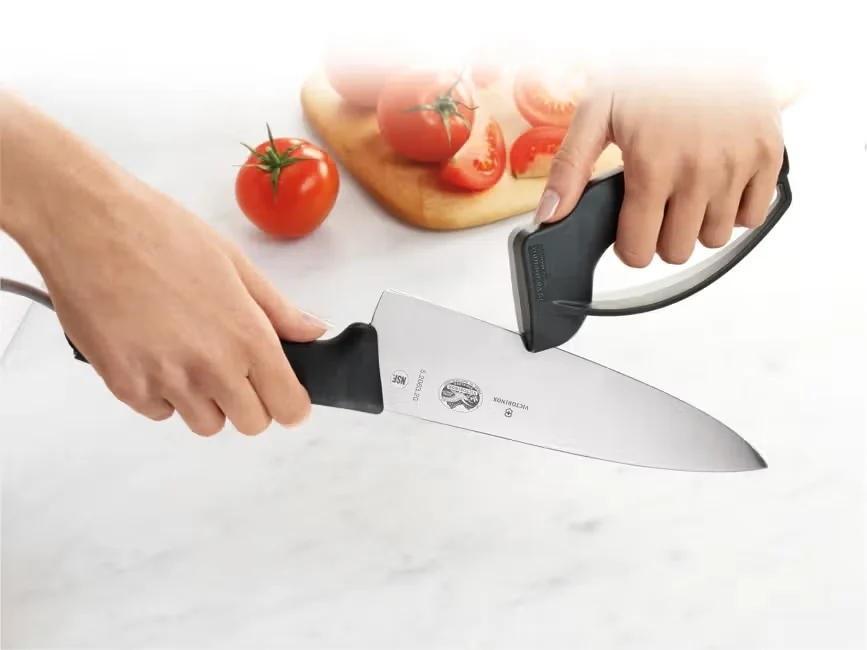 Victorinox Fibrox Pro 8-inch chef's knife in use, slicing tomatoes on a cutting board