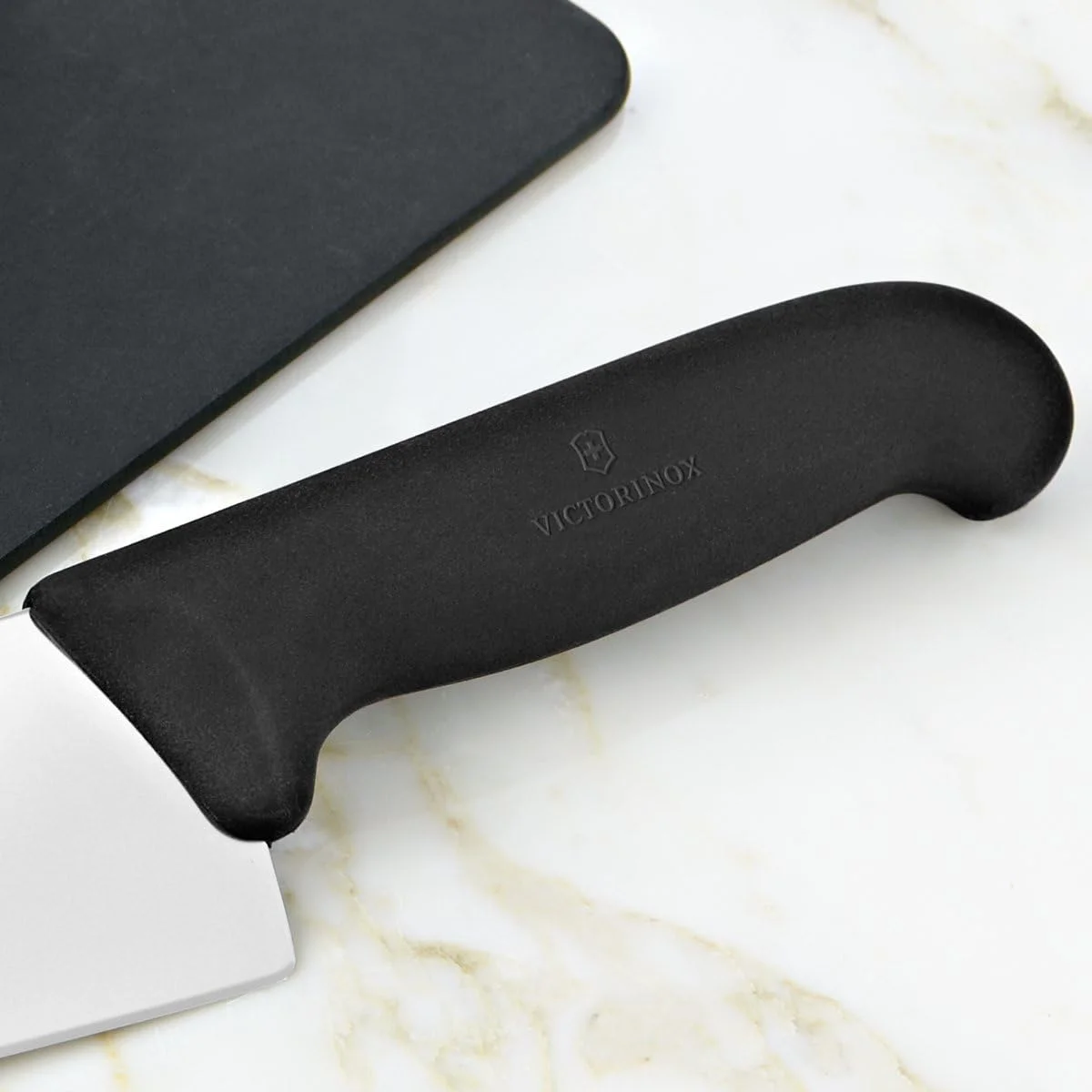 Close-up of the Victorinox Fibrox Pro chef's knife handle and bolster showing the grippy black TPE Fibrox grip