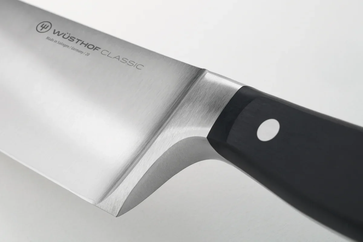 Close-up of the Wusthof Classic 8-inch Chef's Knife's full bolster where the forged blade meets the handle