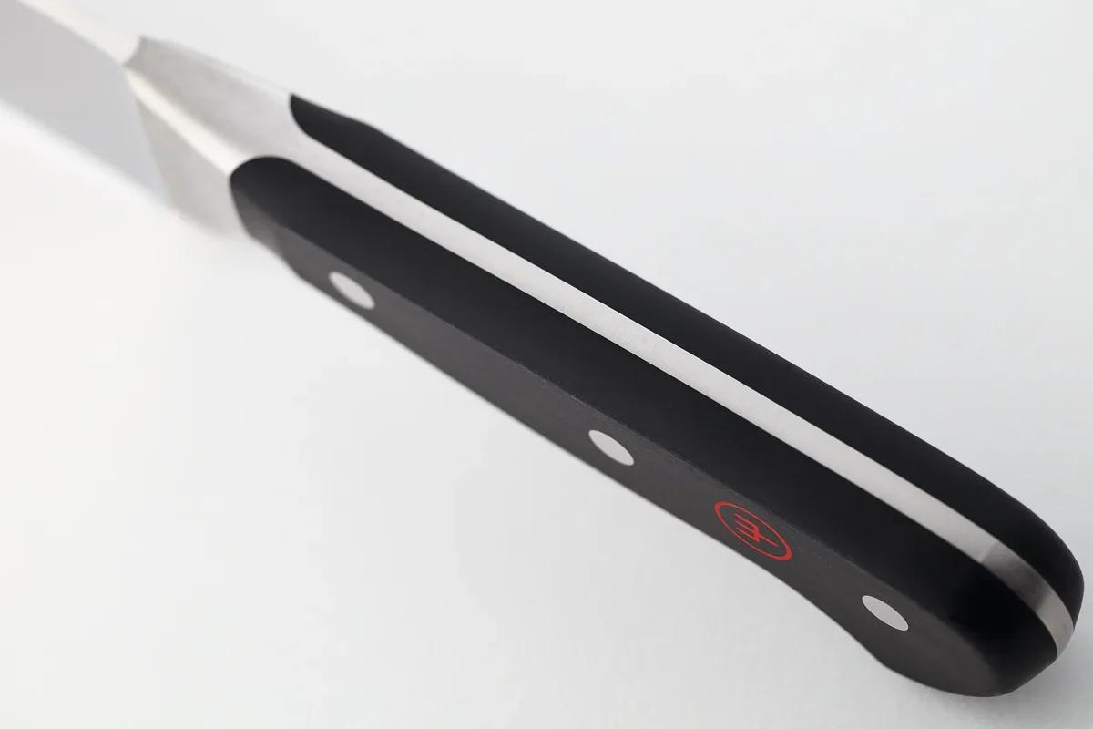 Close-up of the Wusthof Classic 8-inch Chef's Knife's full tang running through the handle spine