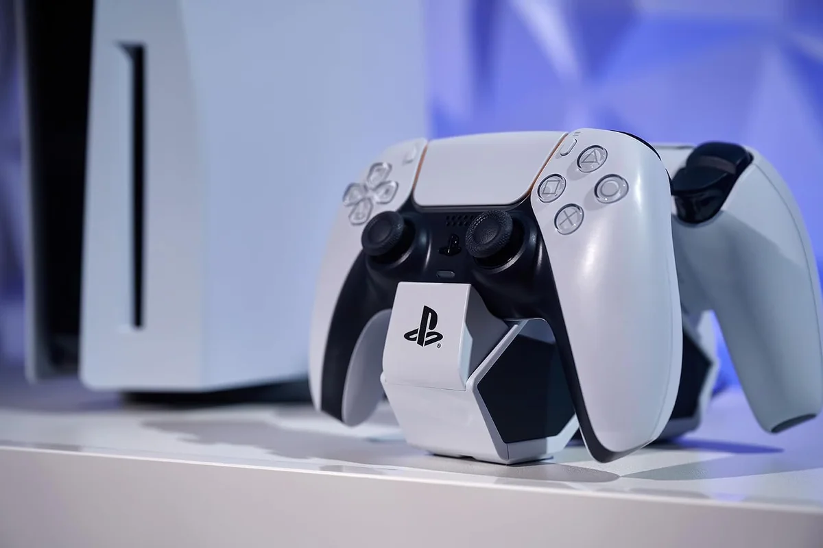 PowerA Twin Charging Station in use with a DualSense controller docked beside a PlayStation 5 console