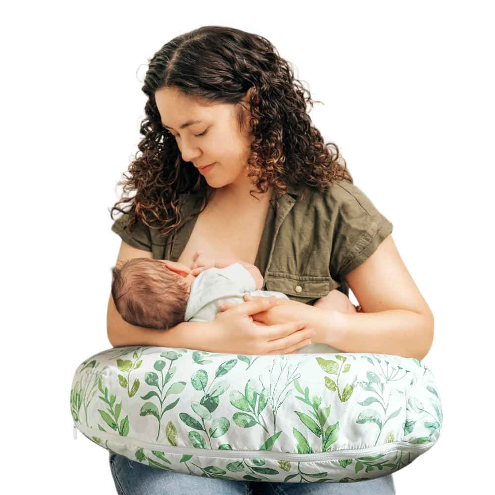 Mother breastfeeding newborn using Boppy Original Nursing Pillow, green leaf cover