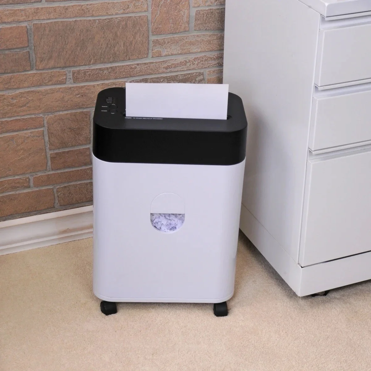 Royal 14MC shredder in use with paper being fed into the feed slot beside a filing cabinet