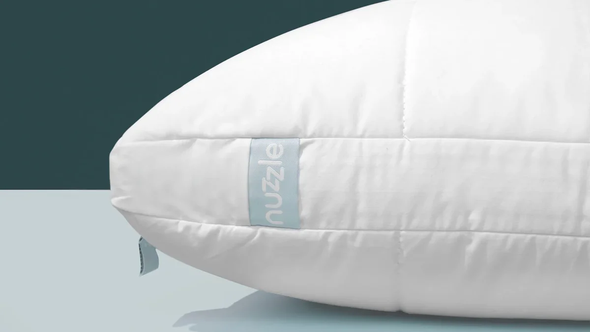 Nuzzle Pillow close-up showing phase-change cooling fabric and zipper