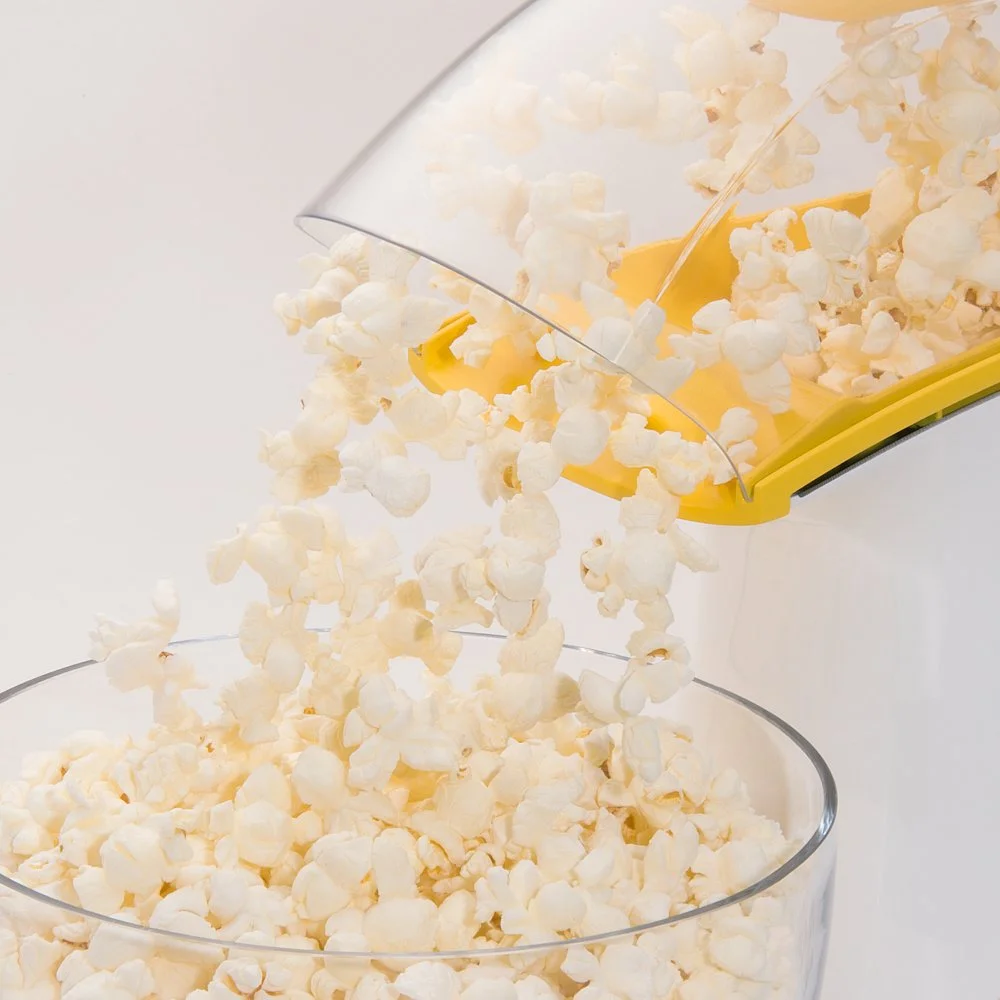 Presto PopLite butter melter measuring cup pouring unpopped kernels into the popping chamber