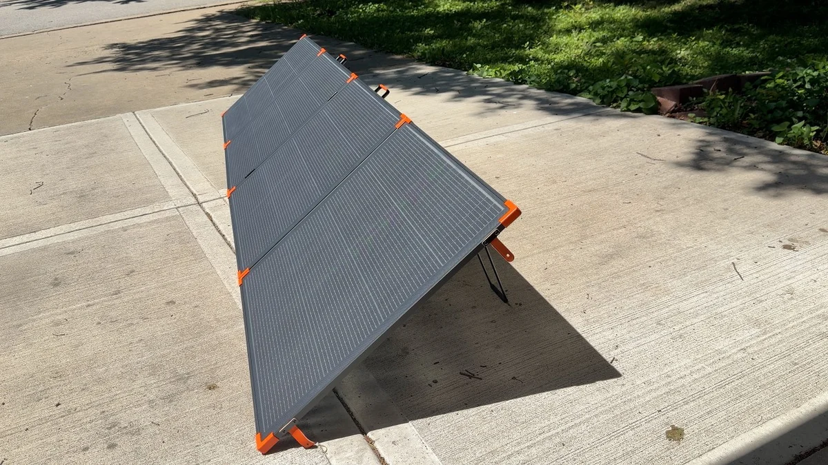 ZOUPW 480W Bifacial solar panel deployed on a concrete sidewalk outdoors, 3/4 angle showing kickstand legs
