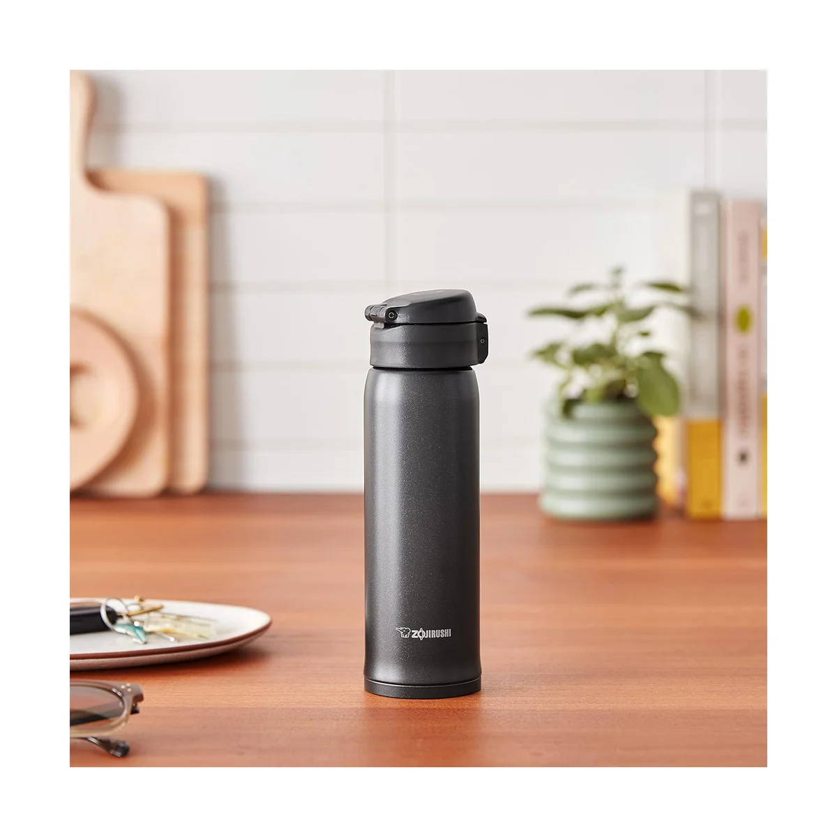 Zojirushi SM-SHE48 travel mug on a wooden desk in a kitchen setting