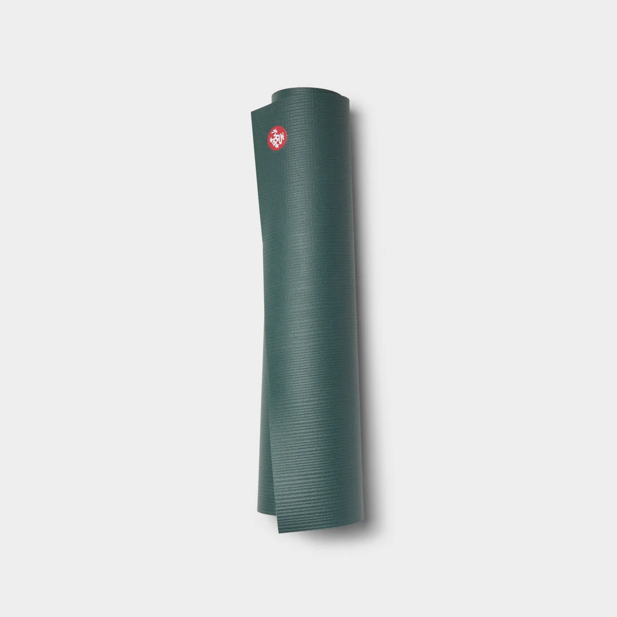 Manduka PRO yoga mat rolled up, Black Sage colorway, showing color variant and logo badge