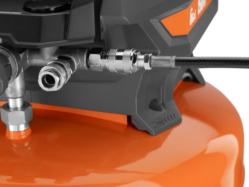 Close-up of the RIDGID compressor's dual universal quick-connect couplers with an air hose attached