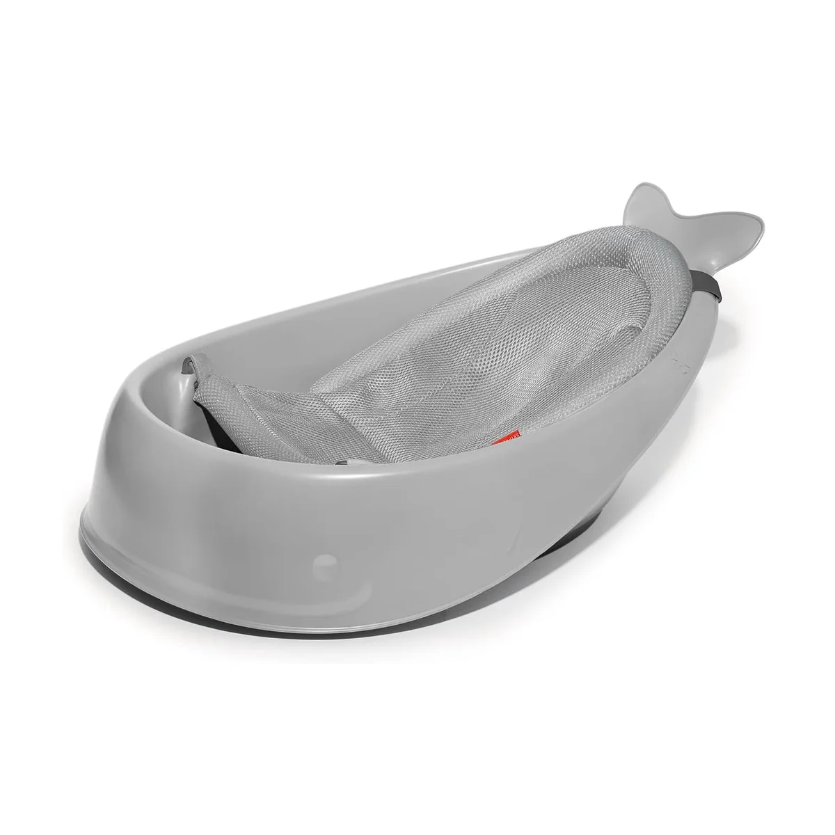 Skip Hop Moby Smart Sling 3-Stage Tub, grey whale-shaped baby bathtub with mesh newborn sling, angled studio view on white