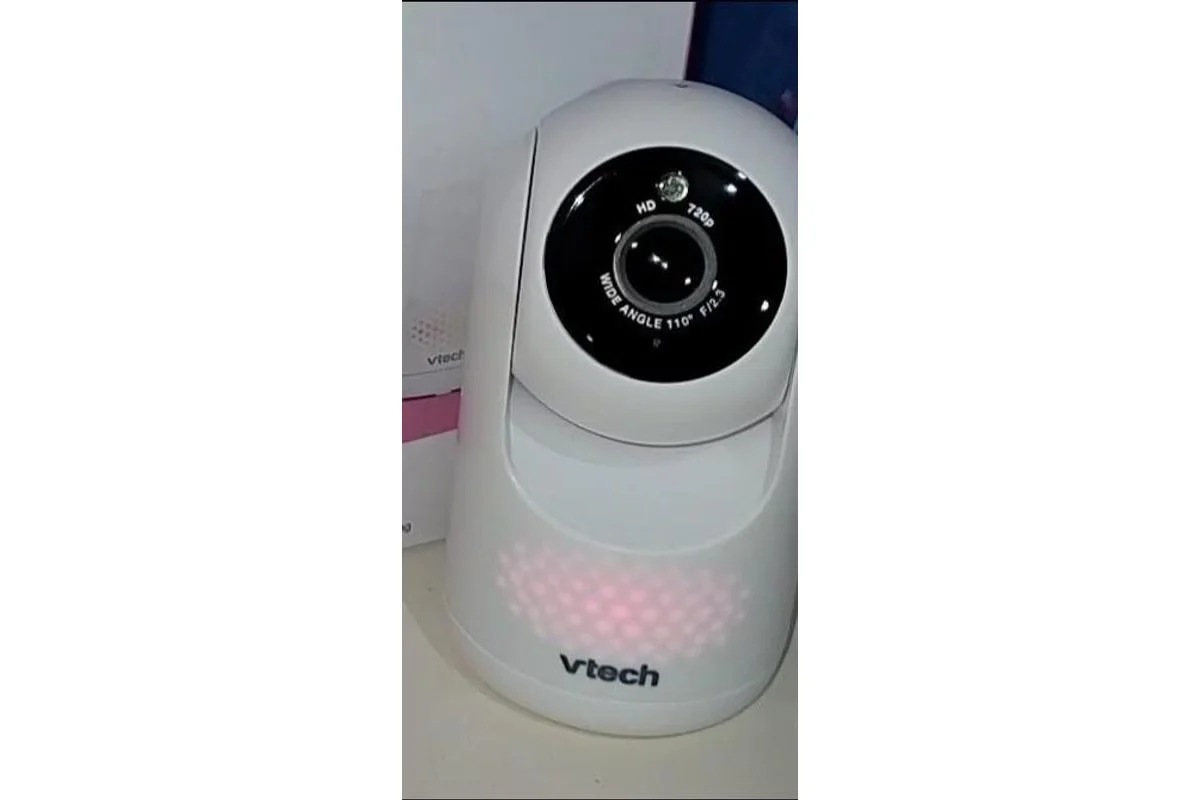 VTech Advanced HQ Max camera unit close-up with pink color night light glowing, showing the HD 720p lens and wide-angle camera