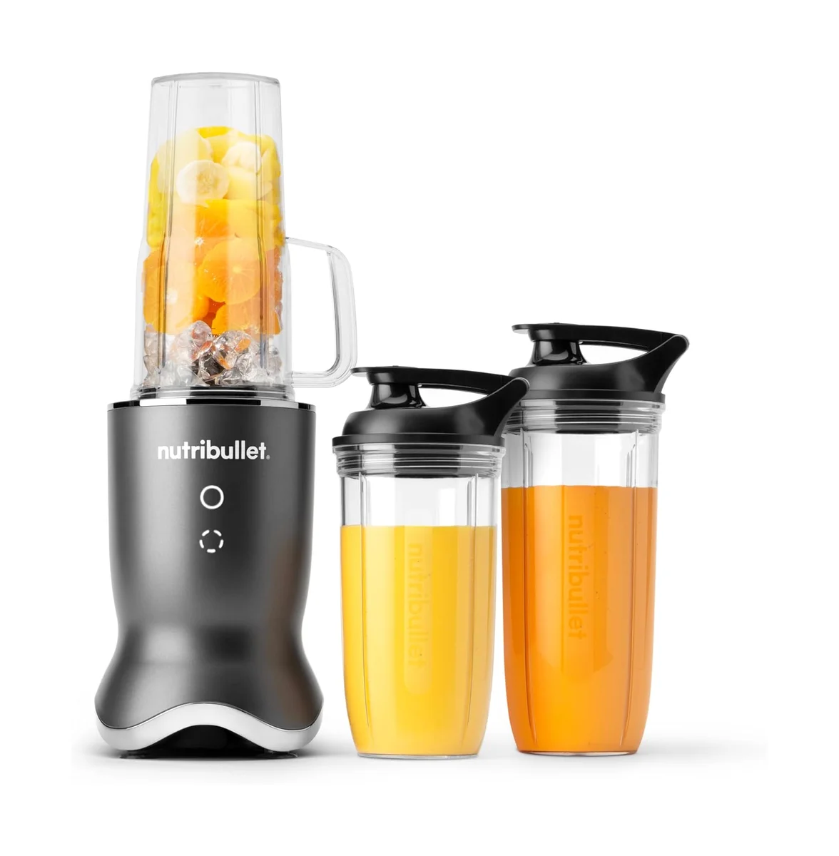 Nutribullet Ultra in dark grey with blending cup filled with banana and mango, alongside two to-go cups with fresh orange juice