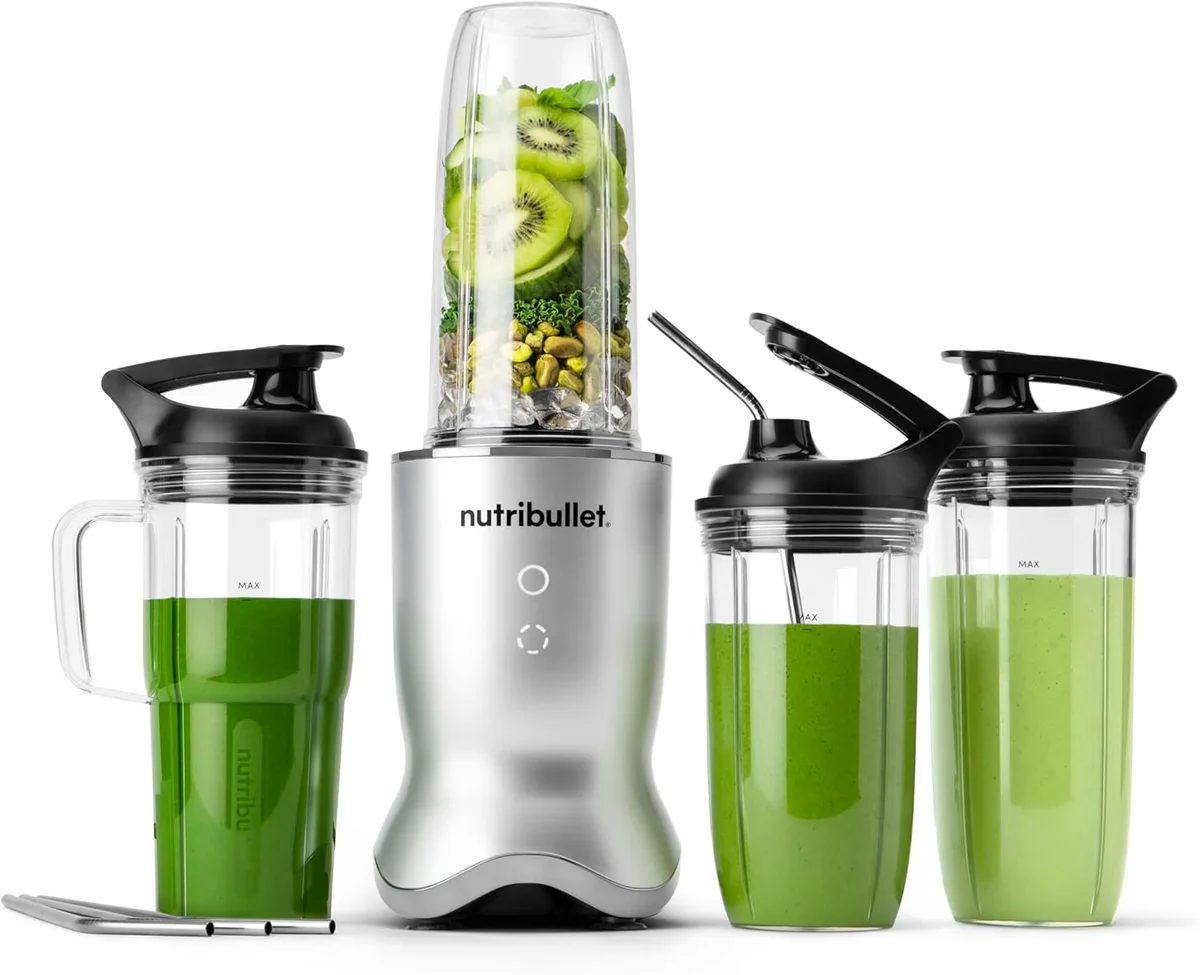 Nutribullet Ultra in silver showing full system with blending cup filled with kiwi and greens, handled cup with green smoothie, and two to-go cups