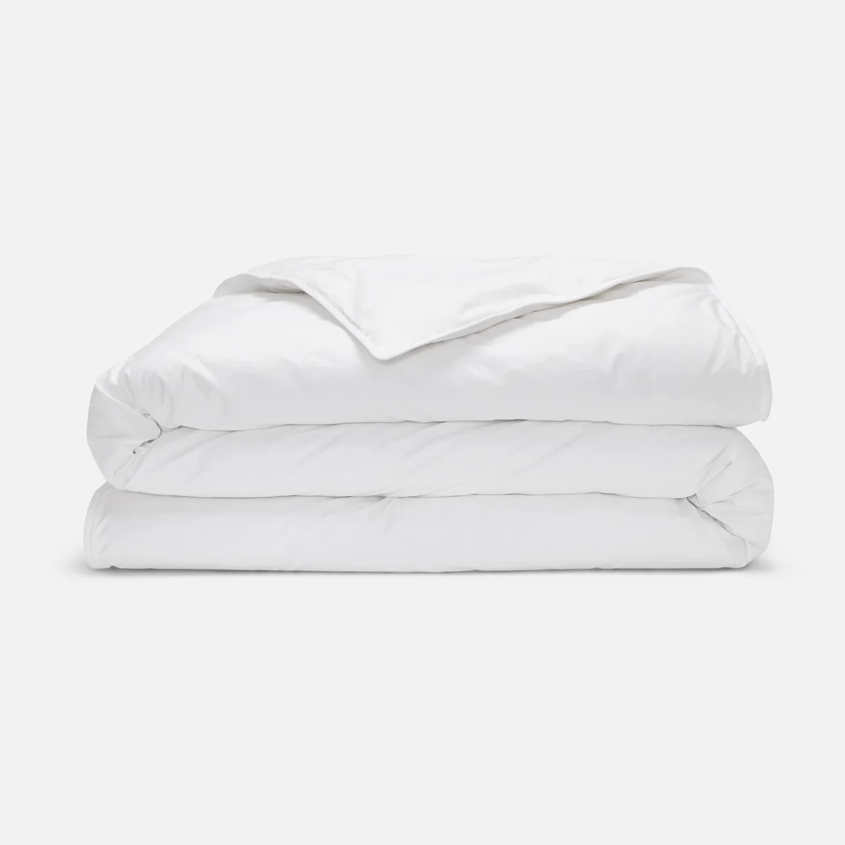 Brooklinen Down Comforter (All-Season) folded on a white studio backdrop