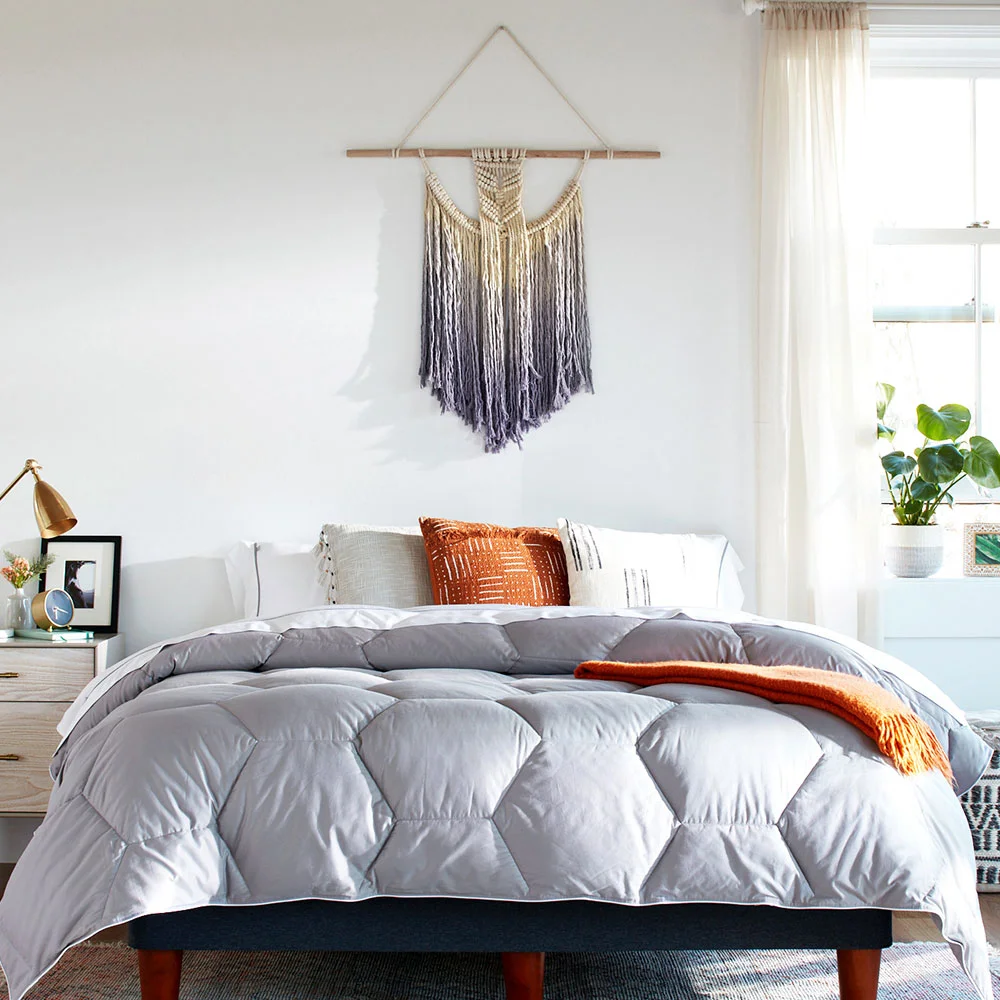 Layla Down Alternative Comforter in grey on a made bed showing hexagonal baffle-box stitching