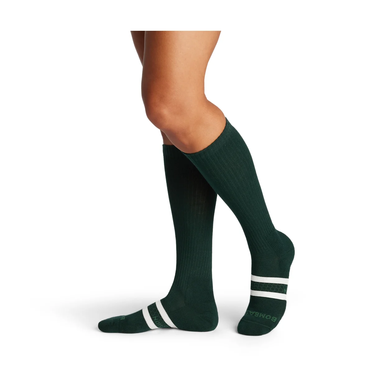 Bombas Everyday Compression Socks in midnight forest green worn on model, side profile showing knee-high compression fit