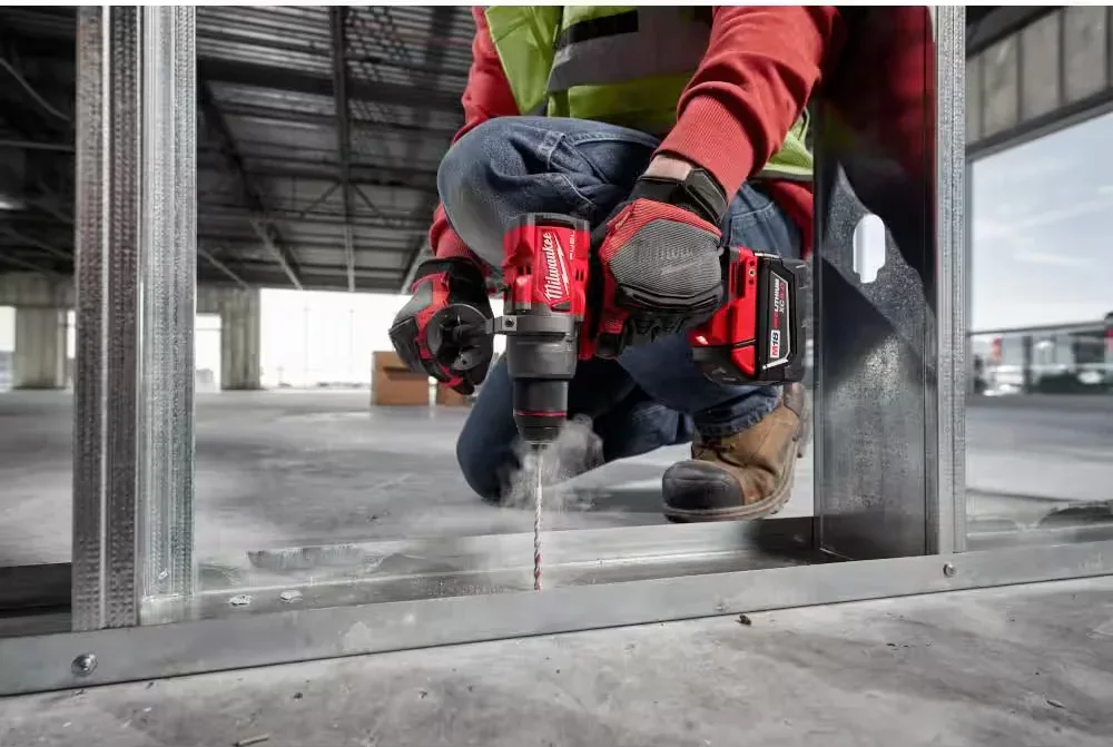 Milwaukee M18 FUEL hammer drill in use drilling into concrete floor on a construction site
