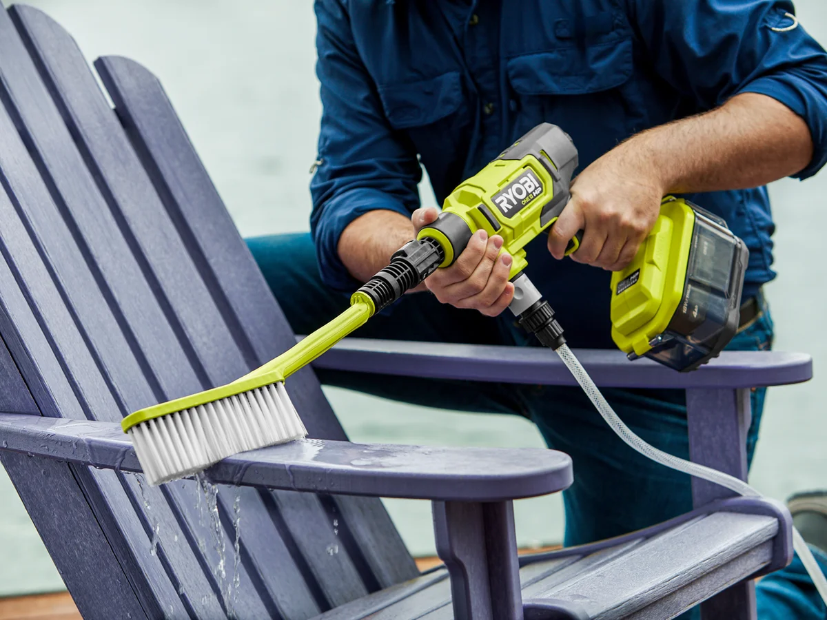 Ryobi EZClean with brush attachment cleaning patio furniture outdoors