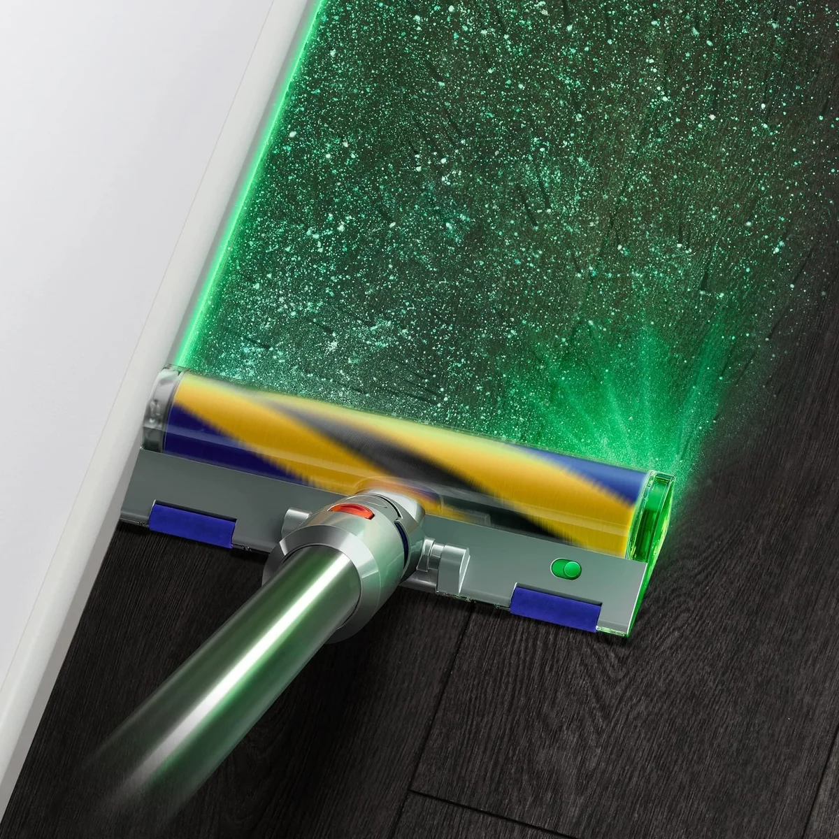 Dyson V15 Detect Fluffy Optic head green laser illuminating dust on hardwood floor