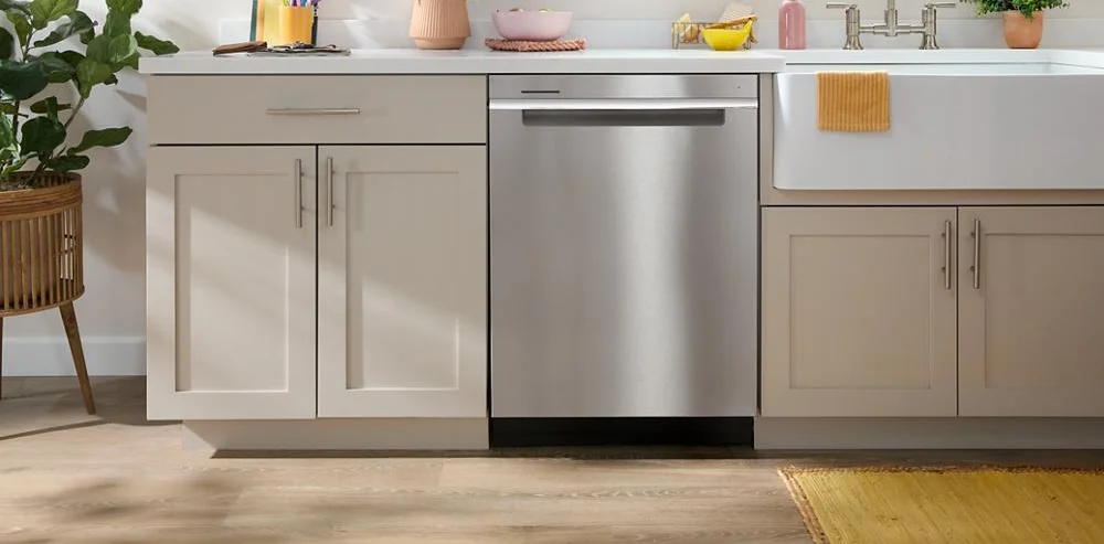 Whirlpool WDTA50SAKZ installed in a cream-cabinet kitchen next to a farmhouse sink