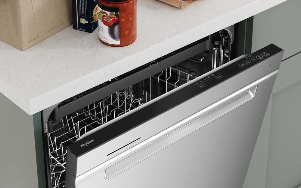 Whirlpool WDTA50SAKZ door slightly ajar showing hidden control console and interior dish rack