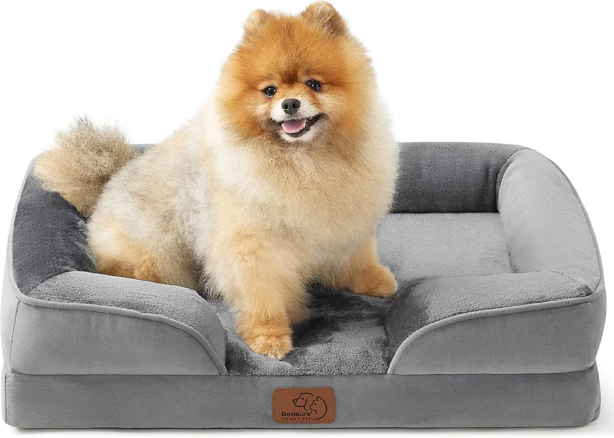 Bedsure orthopedic dog bed in gray with raised bolster sides on a white background, egg-crate foam base with a small dog sitting on it
