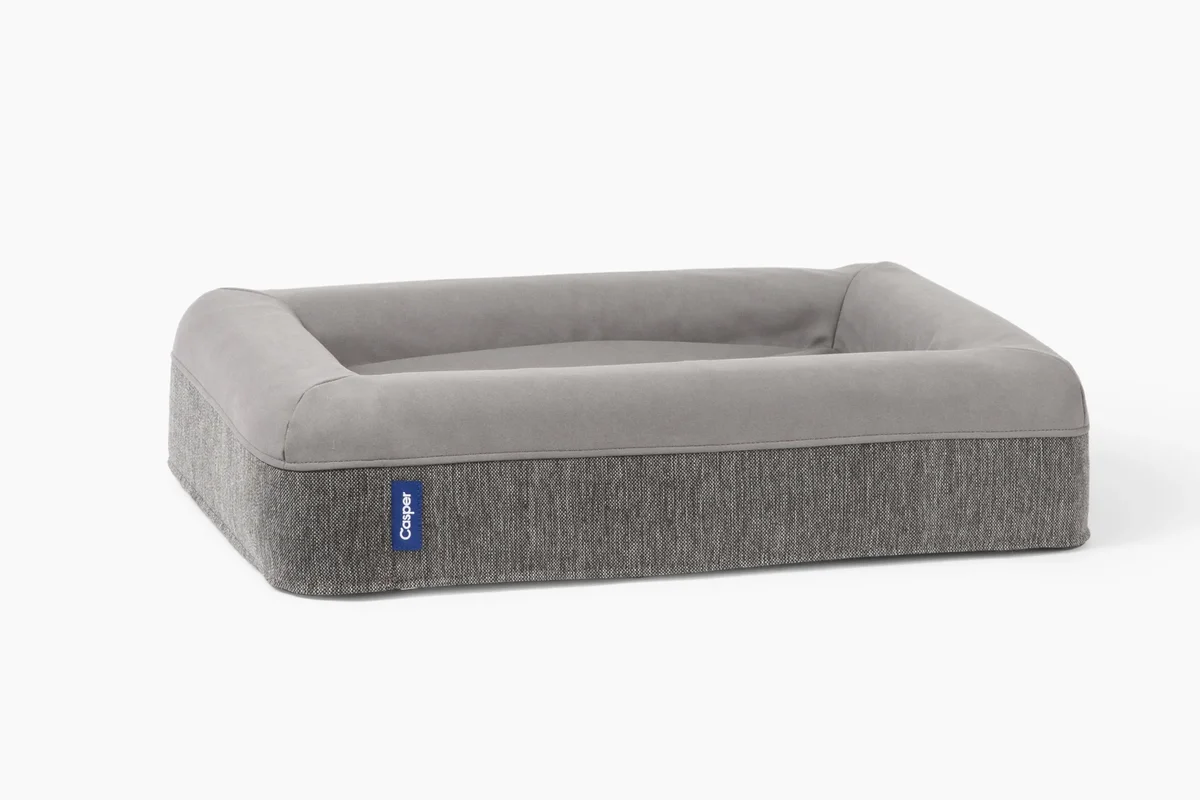Casper Dog Bed in gray, clean 3/4 studio angle showing the memory foam bolster rim and herringbone cover fabric