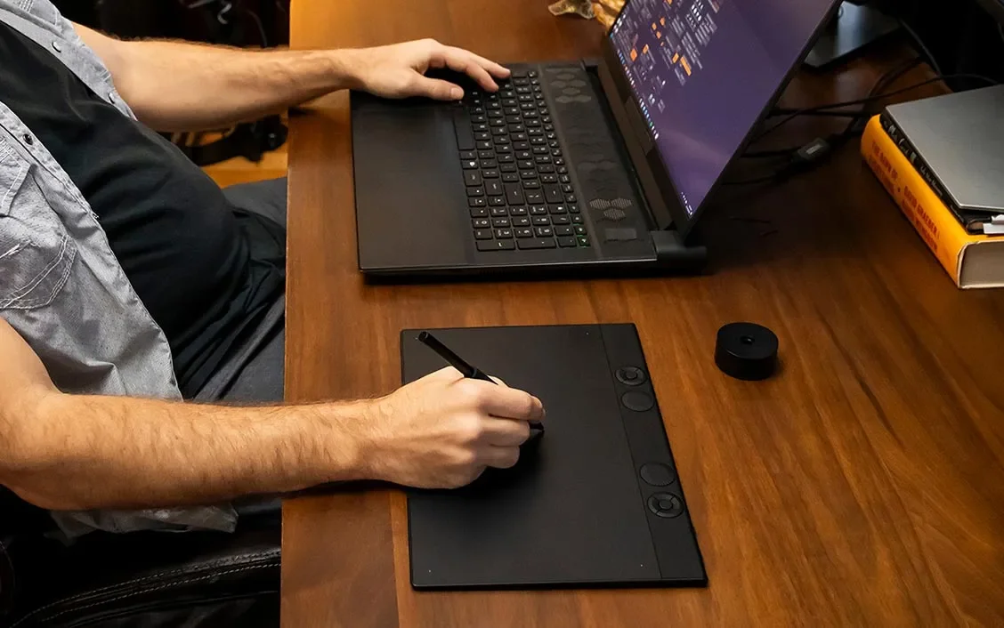 Wacom Intuos Pro Medium in use on a desk alongside a laptop