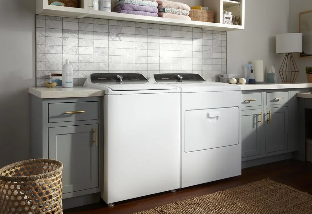 Whirlpool WED5010LW dryer and matching washer in a laundry room with tile backsplash