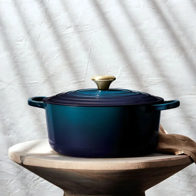 Le Creuset Signature Round Dutch Oven in Agave blue, side profile on a wooden pedestal