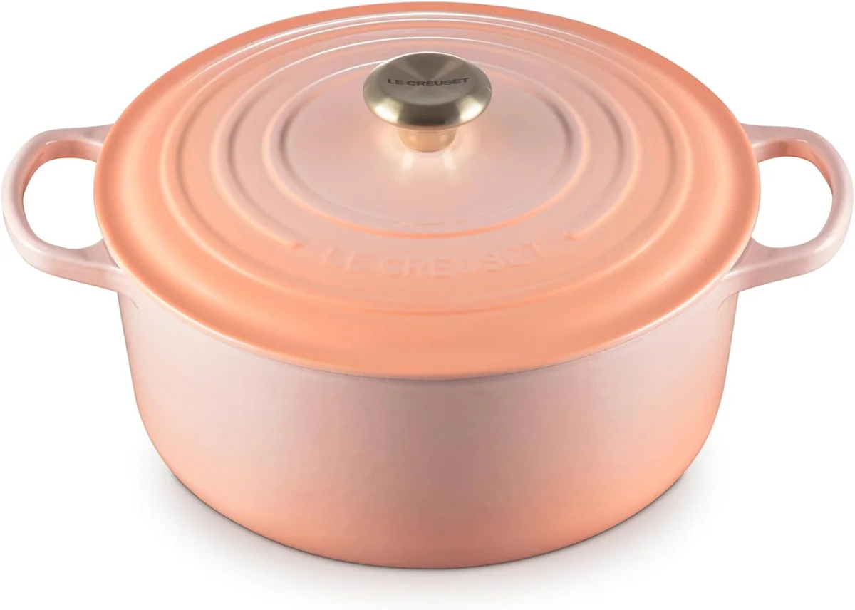 Le Creuset Signature Round Dutch Oven in Peche, front three-quarter view with lid on