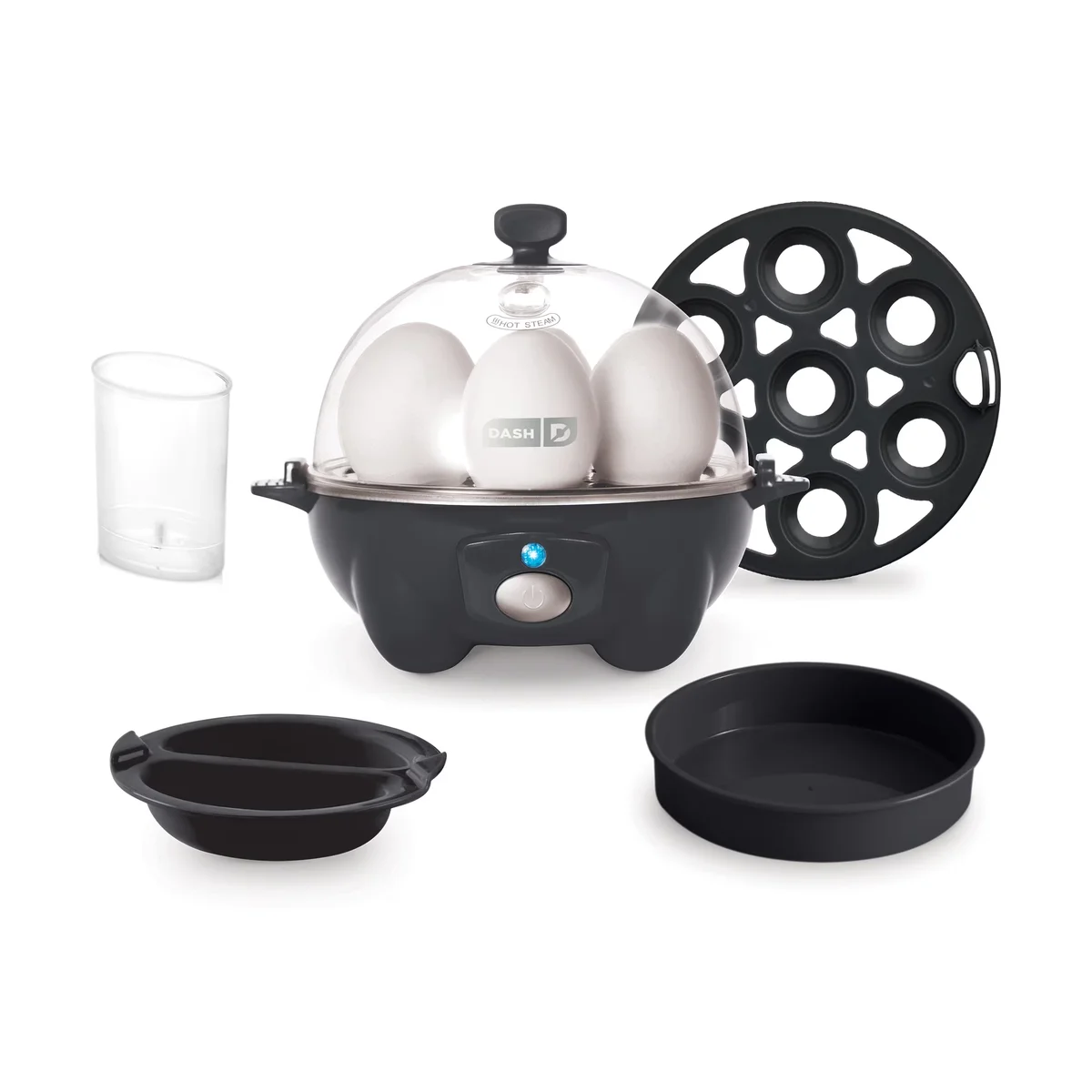 Dash Rapid Egg Cooker in black with its included accessories: boiling tray, poaching tray, omelet bowl and measuring cup