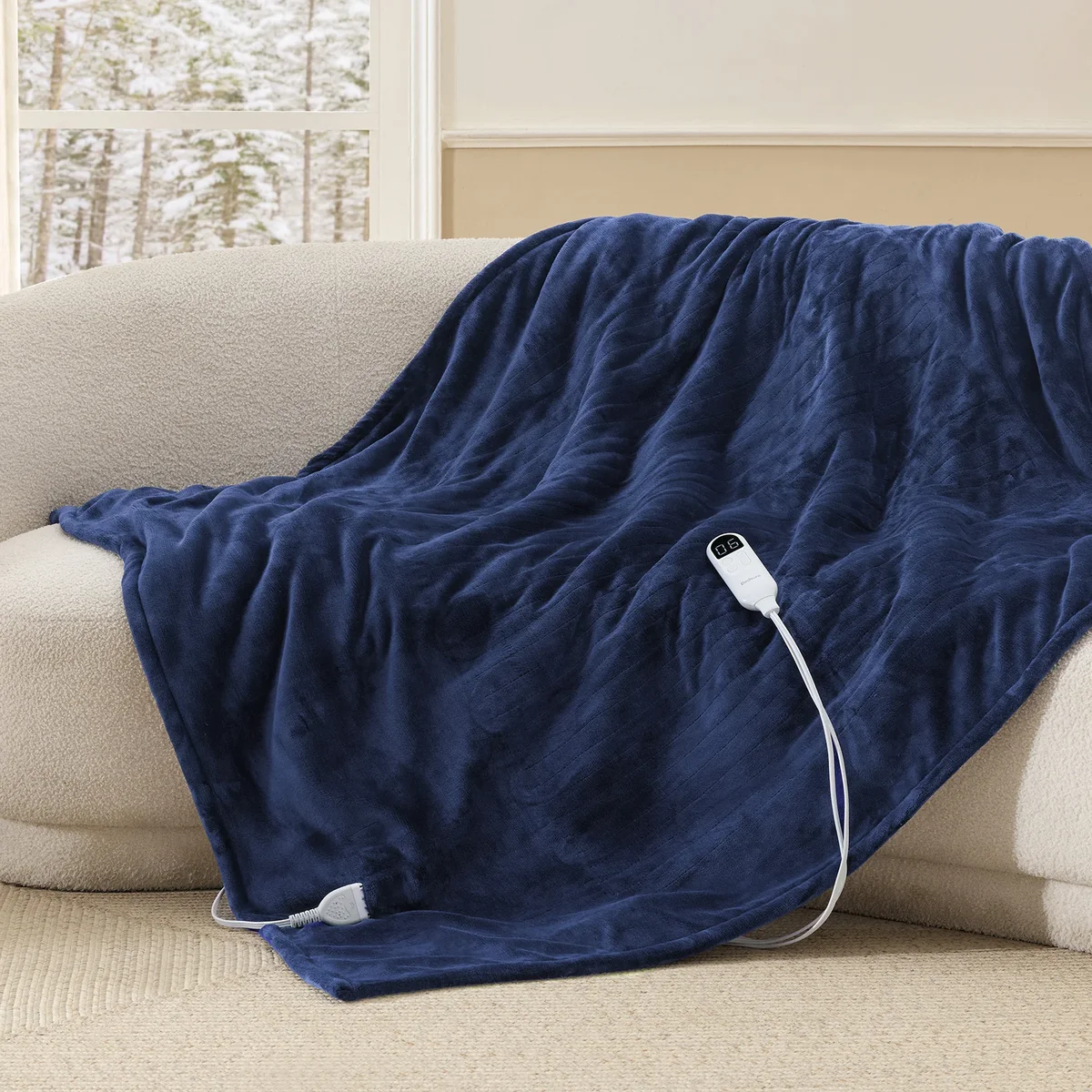 Bedsure GentleSoft heated blanket draped over a sofa showing its full drape and controller
