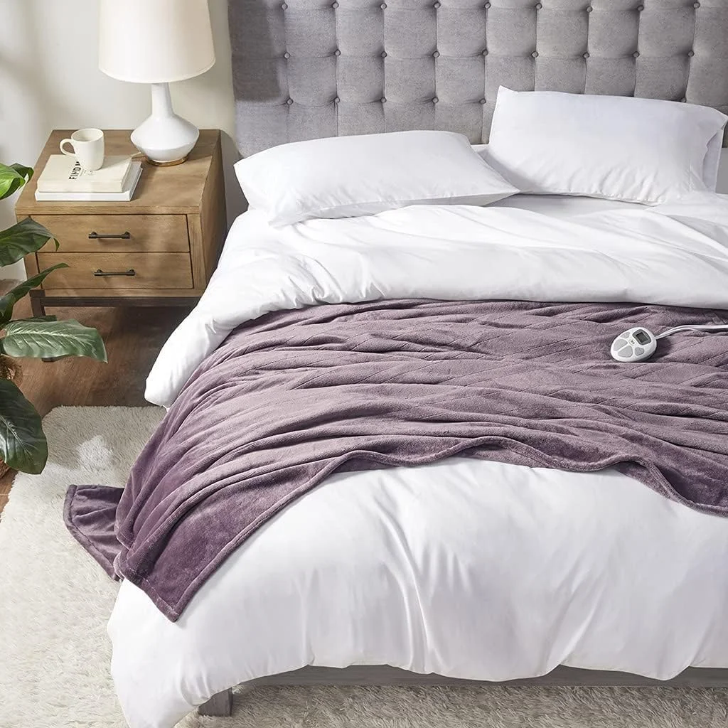 Serta Luxuriously Soft Plush heated blanket in mauve draped across a made bed