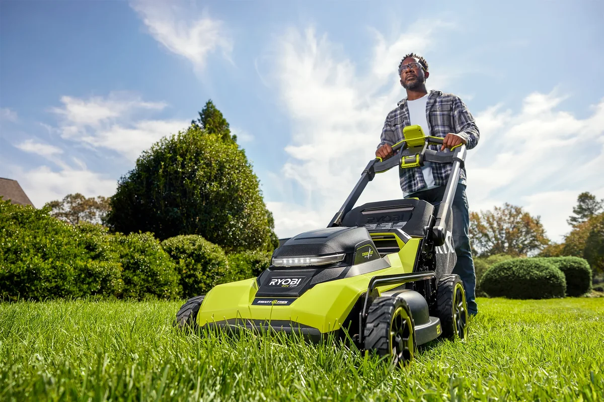 Ryobi 40V HP CrossCut mower being used on lawn, low-angle lifestyle shot