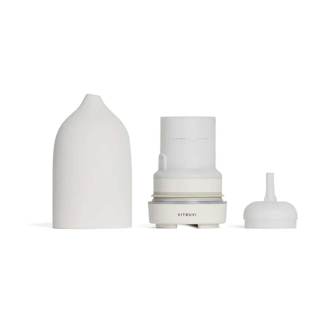Vitruvi Stone Diffuser taken apart: the white ceramic cover lifted off, the water tank and base with its fill line, and the separate inner lid