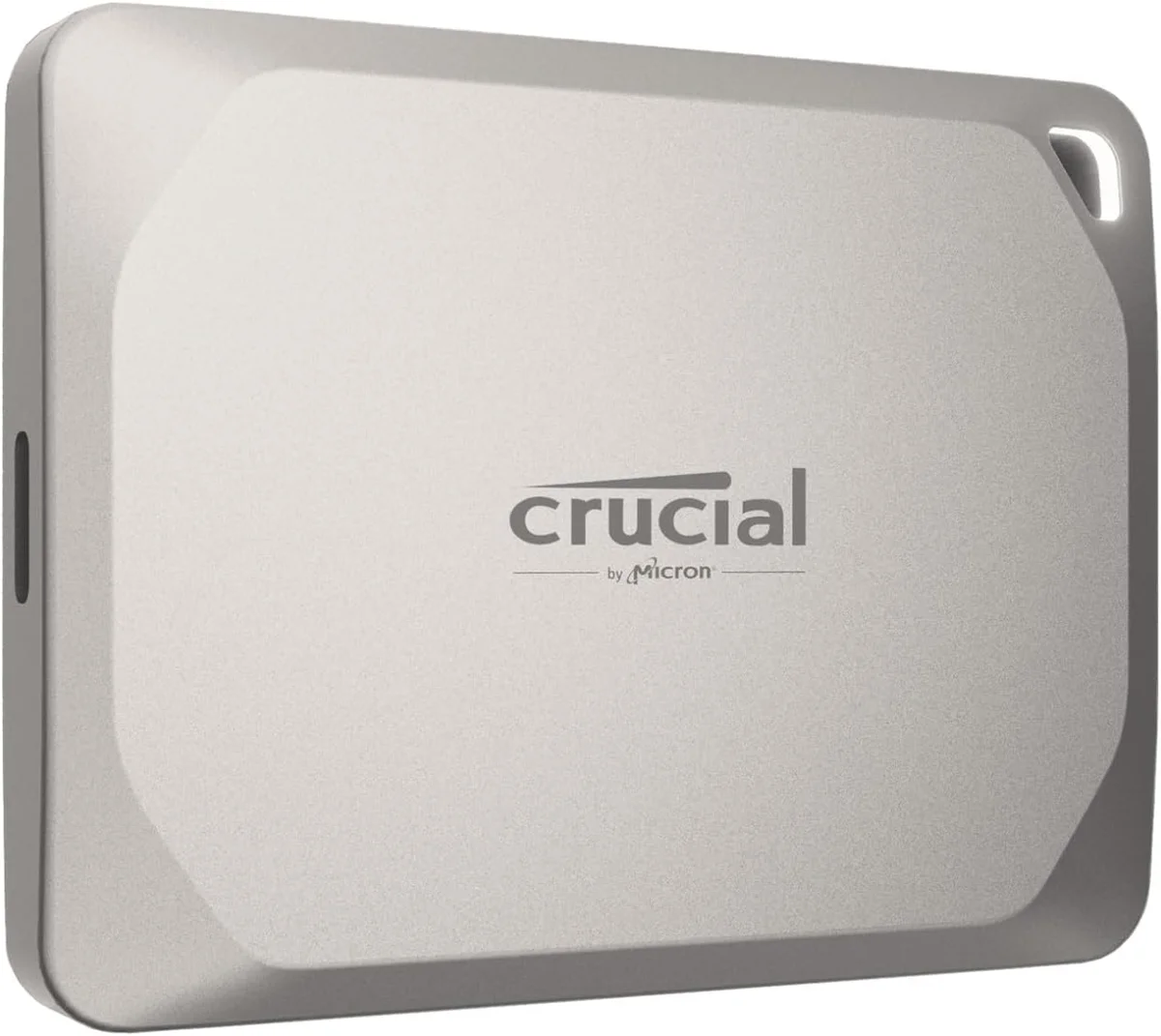 Crucial X9 Pro portable SSD, a small silver aluminum drive with the Crucial logo and a corner lanyard hole, shown at a three-quarter angle
