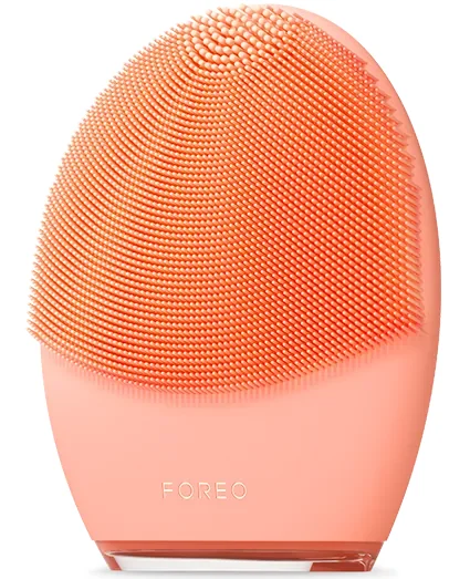 FOREO LUNA 4 facial cleansing device in peach coral front view