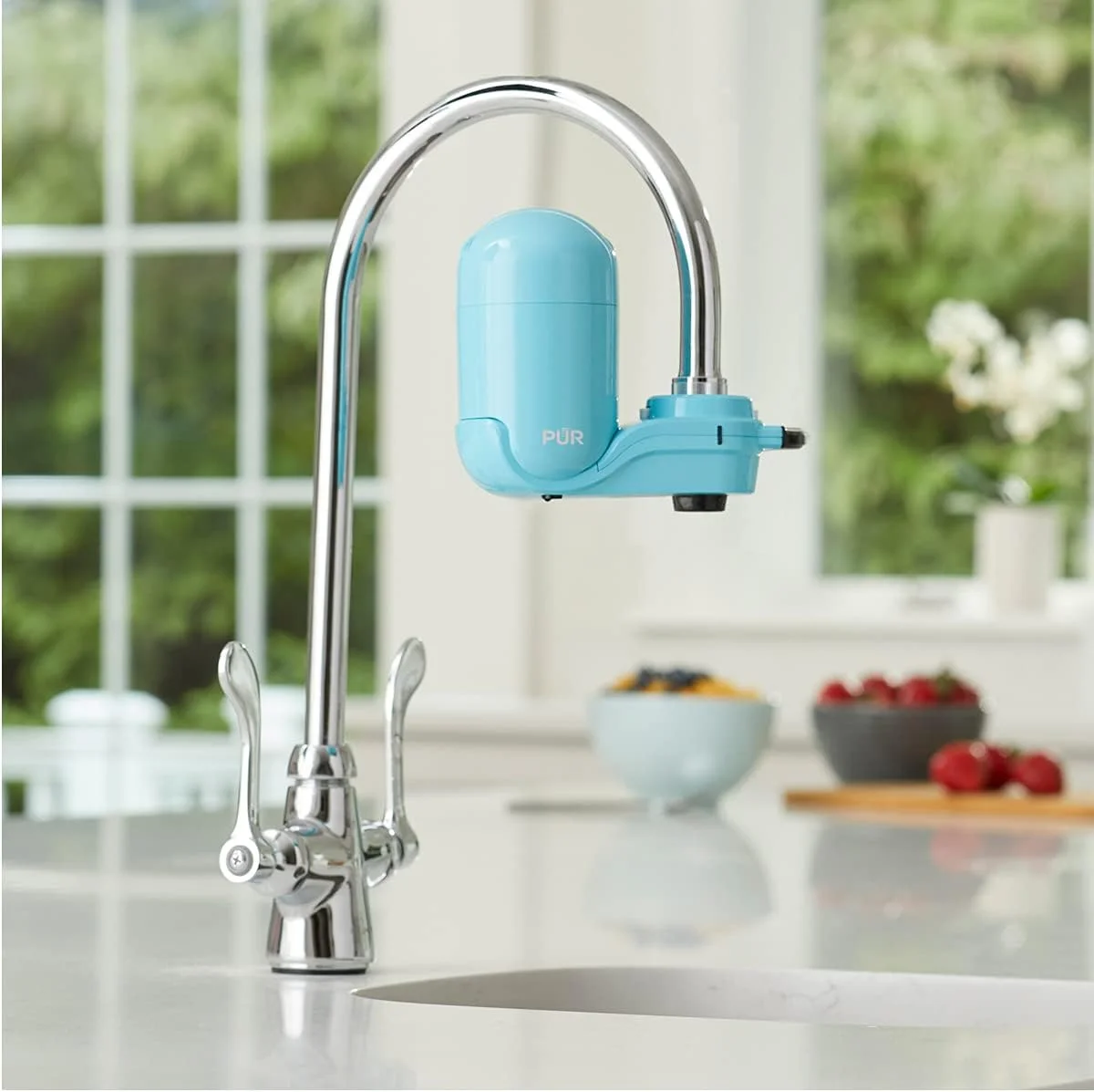 PUR Plus faucet filter installed on kitchen faucet in bright kitchen setting