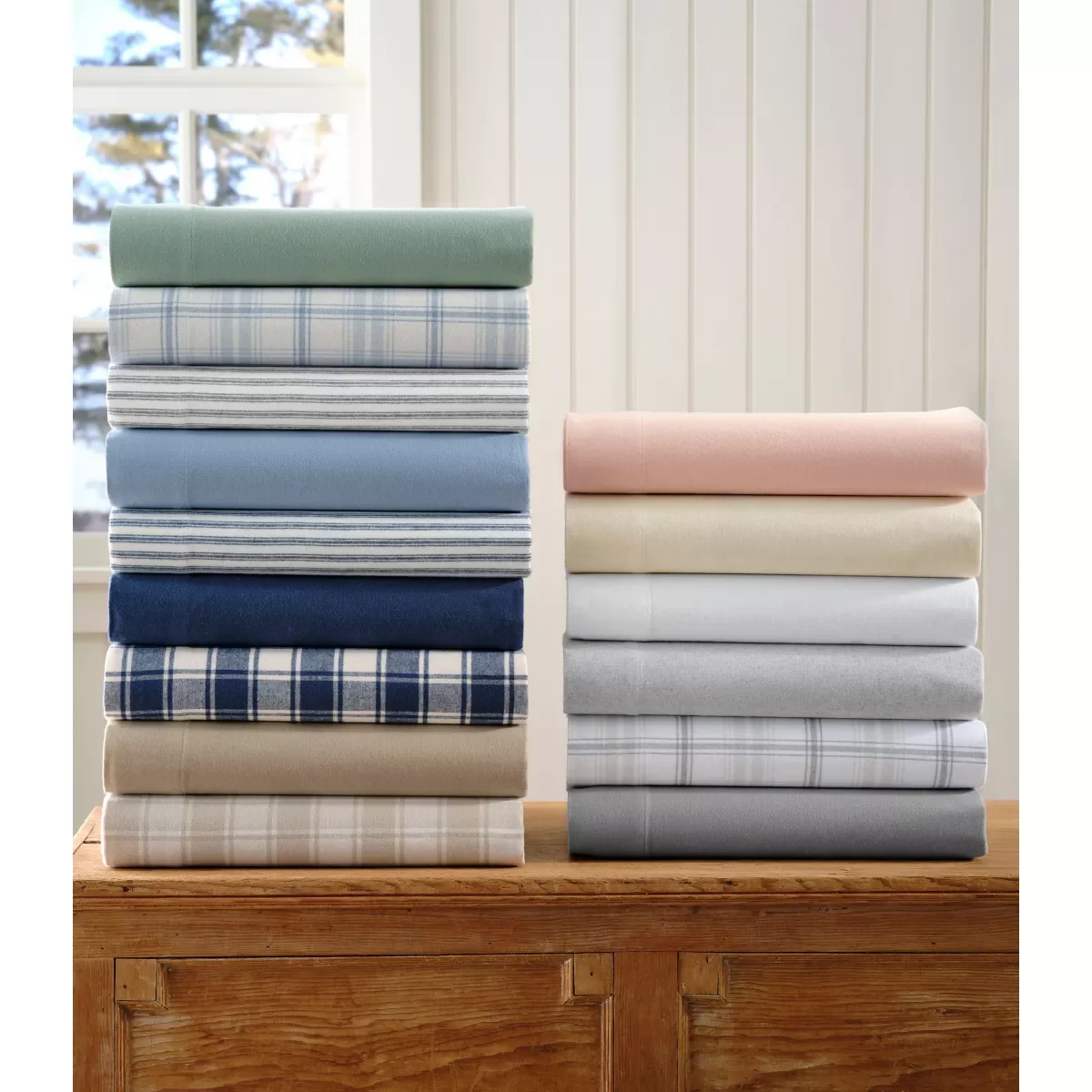 L.L. Bean Ultrasoft Comfort Flannel sheet sets folded in the full color range on a wood dresser