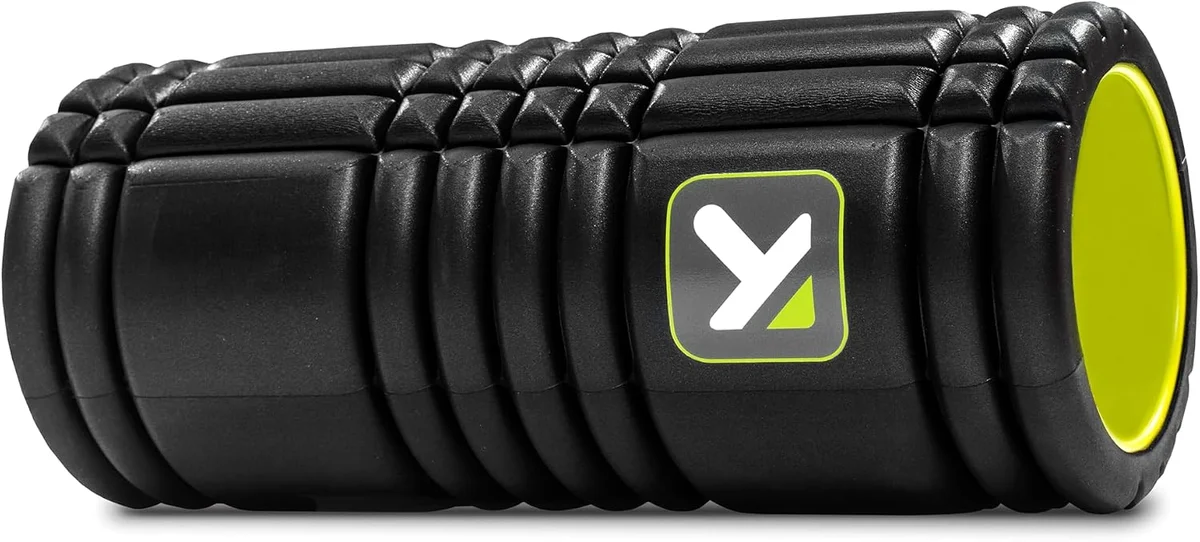TriggerPoint GRID 1.0 black foam roller angled to show the hollow core end cap with lime green interior