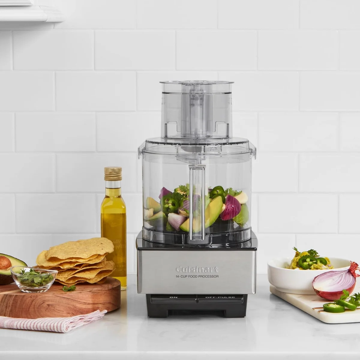 Cuisinart Custom 14-Cup Food Processor on a kitchen counter prepping guacamole ingredients like avocado, onion, and jalapeno