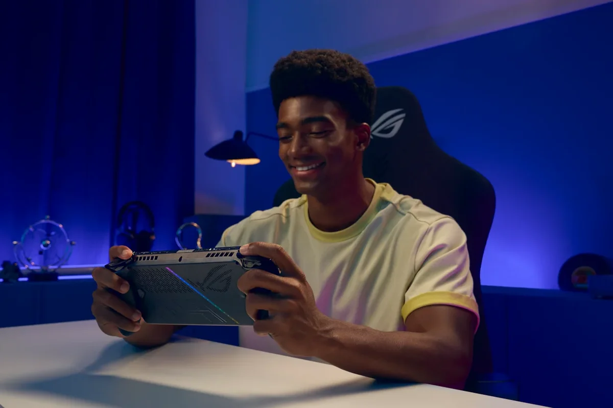 ASUS ROG Xbox Ally X in use — person gaming at a desk in a blue-lit setup