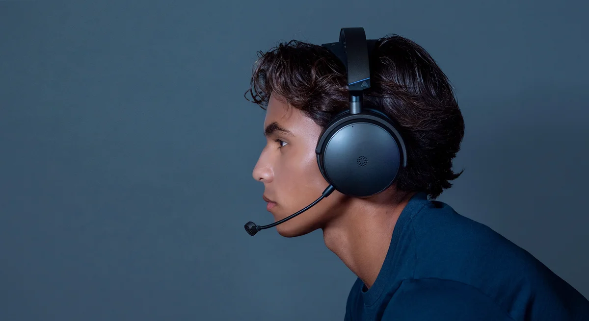 Gamer wearing the Audeze Maxwell 2 headset with the boom mic attached, side profile